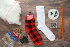 various items are laid out on a wooden surface including socks, buttons and other crafting supplies