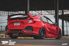 a red sports car parked in front of a building