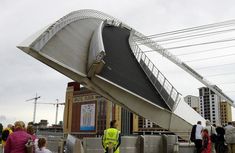 people are standing around and looking at an upside down structure