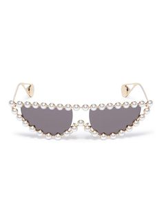 Gucci's retro-inspired cat-eye sunglasses have slender gold-tone metal frames that are outlined in lustrous faux pearls and tipped with the label's signature mono Gucci Elegant Luxury Cat Eye Sunglasses, Luxury Gucci Cat Eye Sunglasses For Summer, Elegant Gucci Sunglasses For Spring, Elegant Gucci Cat Eye Sunglasses For Evening, Gold Sunglasses For Spring Evening, Luxury Gold Cat Eye Sunglasses For Party, Gucci Cat Eye Sunglasses For Party, Designer Cat Eye Sunglasses With Mirrored Lenses For Party, Elegant Party Sunglasses With Metal Frame