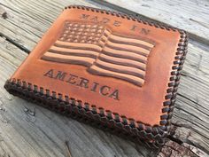 "A Patriotic USA Pride hand-made Leather Bi-fold wallet Features a hand-tooled American Flag design. An outstanding way to proudly display your love for our great country. *Only one of these exists and this one is being offered at a special discount price.* This wallet is 100% Made-In-America DETAILS: - Double looped genuine calf lace - 3 tone dye finish- ( Tan, Dark Brown, Natural) Eco-friendly waterproof finish - Crafted from Herman Oak veg tanned leather- the best hands down - Interior premiu Custom Handmade Rectangular Trifold Wallet, Custom Handmade Trifold Wallet, Customizable Brown Bifold Wallet, Custom Rectangular Trifold Wallet With Coin Pocket, Custom Rectangular Wallets As Gifts, Custom Rectangular Wallets For Gift, Usa Pride, American Flag Design, Biker Wallet