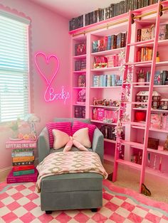 a bedroom with pink walls and shelves filled with books