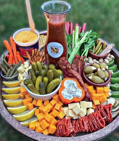 a platter filled with assorted vegetables and dips