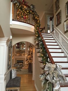 a staircase decorated with christmas garland and lights