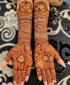 two hands with henna designs on them