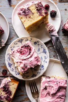 slices of cake with raspberry frosting on plates next to a knife and fork