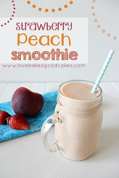 a smoothie in a mason jar with strawberries next to it on a blue towel