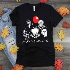 a black shirt that says friends with two clowns and a red balloon on it