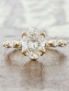 an oval cut diamond ring with two side stones