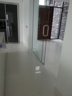 an empty room with glass doors and white walls