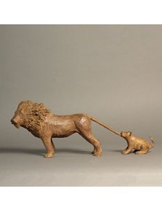 a lion and cub figurine on a gray background