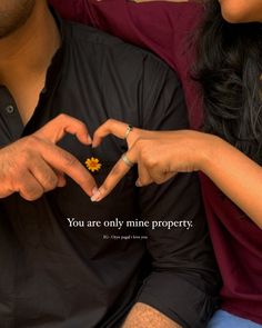 two people making a heart shape with their hands and the words you are only mine property