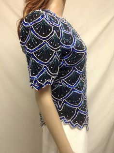 "Beaded Sequin Top, Blue ,Green, White, Formal top,medium,Large Zipper and hook clasp close. Lined Measurements: Bust 35\" waist 34\" Hips 39\" Excellent Condition No size or maker tag but I had one exactly like this that said Laurence Kazar on it Free shipping in the US NK248F4 Beaded Sequin Top, Blue ,Green, White, Formal top,medium,Large" Elegant Blue Embellished Top, Fitted Blue Embellished Blouse, Blue Embellished Party Blouse, Fitted Beaded Short Sleeve Tops, Blue Embellished Top For Evening, Beaded Short Sleeve Tops For Evening, Fitted Blue Beaded Tops, Blue Beaded Tops For Spring, Beaded Blue Tops For Spring