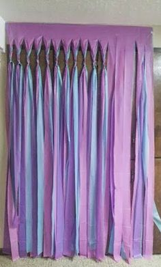 purple and blue curtains are hanging on the wall