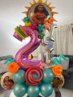 the birthday cake is decorated with balloons and decorations