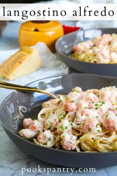 two bowls filled with shrimp alfredo and pasta