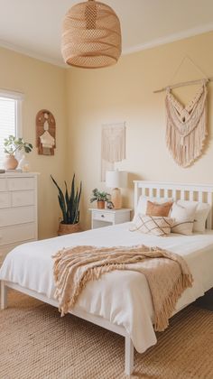 a white bed sitting in a bedroom next to a dresser and lamp on top of a rug