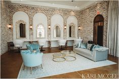 a living room filled with furniture and mirrors