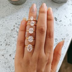 a woman's hand with three rings on it