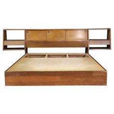 a wooden bed frame with drawers on each side