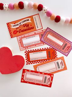 valentine's day coupons are displayed on a table with a heart shaped box