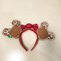 a minnie mouse head with a red bow on it's headband and ears