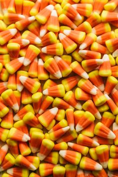 an assortment of candy corn is shown in this close - up photo, which appears to be orange and yellow