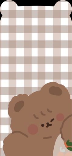 a brown teddy bear holding a carrot in it's hand on a checkered table cloth