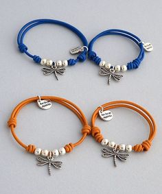 three different bracelets with charms on them