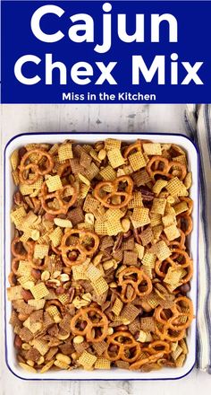 a casserole dish filled with chex mix and the title reads, cajun chex mix miss in the kitchen