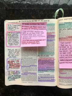 an open bible with sticky notes attached to it