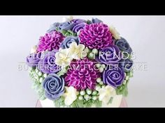 a cake decorated with purple and white flowers