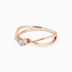 a rose gold ring with three diamonds