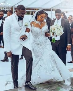 the bride and groom are walking down the aisle