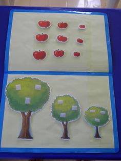 an open book with pictures of trees and apples on it