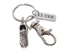 a pair of shoes and a keychain that says i can