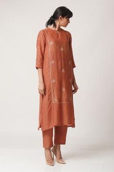 Rust orange kurta with all-over floral motif  work and side seam pockets. Comes with straight pants.
Components:2
Embroidered
Neckline:Round
Sleeve Length:Three Quarter
Fabric:Chanderi
Color:Orange
Side seam pockets
Side slits - Aza Fashions Red Kurta, Kurta Set For Women, V Dress, Cowl Dress, Tier Dress, Rust Dress, Embroidered Neckline, Kurta With Pants, Rust Orange