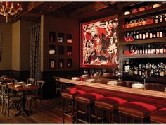 an empty restaurant with many bottles on the shelves