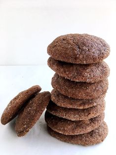 a stack of cookies sitting next to each other on a white counter top with one cookie in the middle