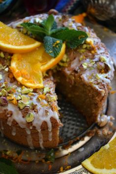 there is a cake with oranges and nuts on it