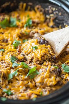 a skillet filled with taco meat and cheese