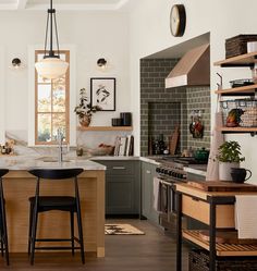 the kitchen is clean and ready to be used for cooking or baking, with two stools in front of the island