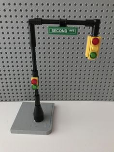 a traffic light sitting on top of a table next to a sign that reads second art