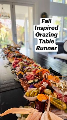 a long table topped with lots of different types of food on top of each other