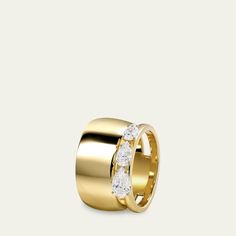 a gold ring with three diamonds on it