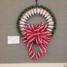 a christmas wreath made out of matchesticks and ribbon