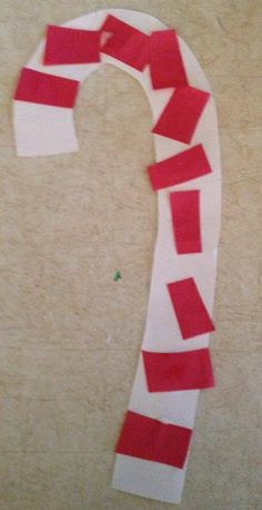 a piece of paper that has been cut into the shape of a letter with red and white strips