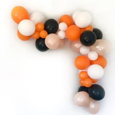 an orange, black and white balloon garland