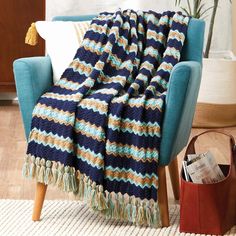 a blue chair with a blanket on it