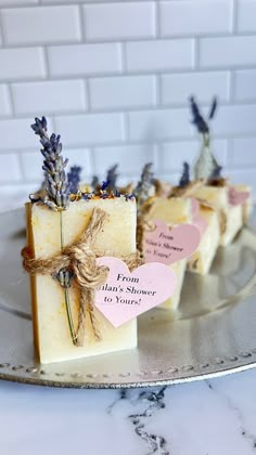 three soap bars with lavender on them sitting on a plate